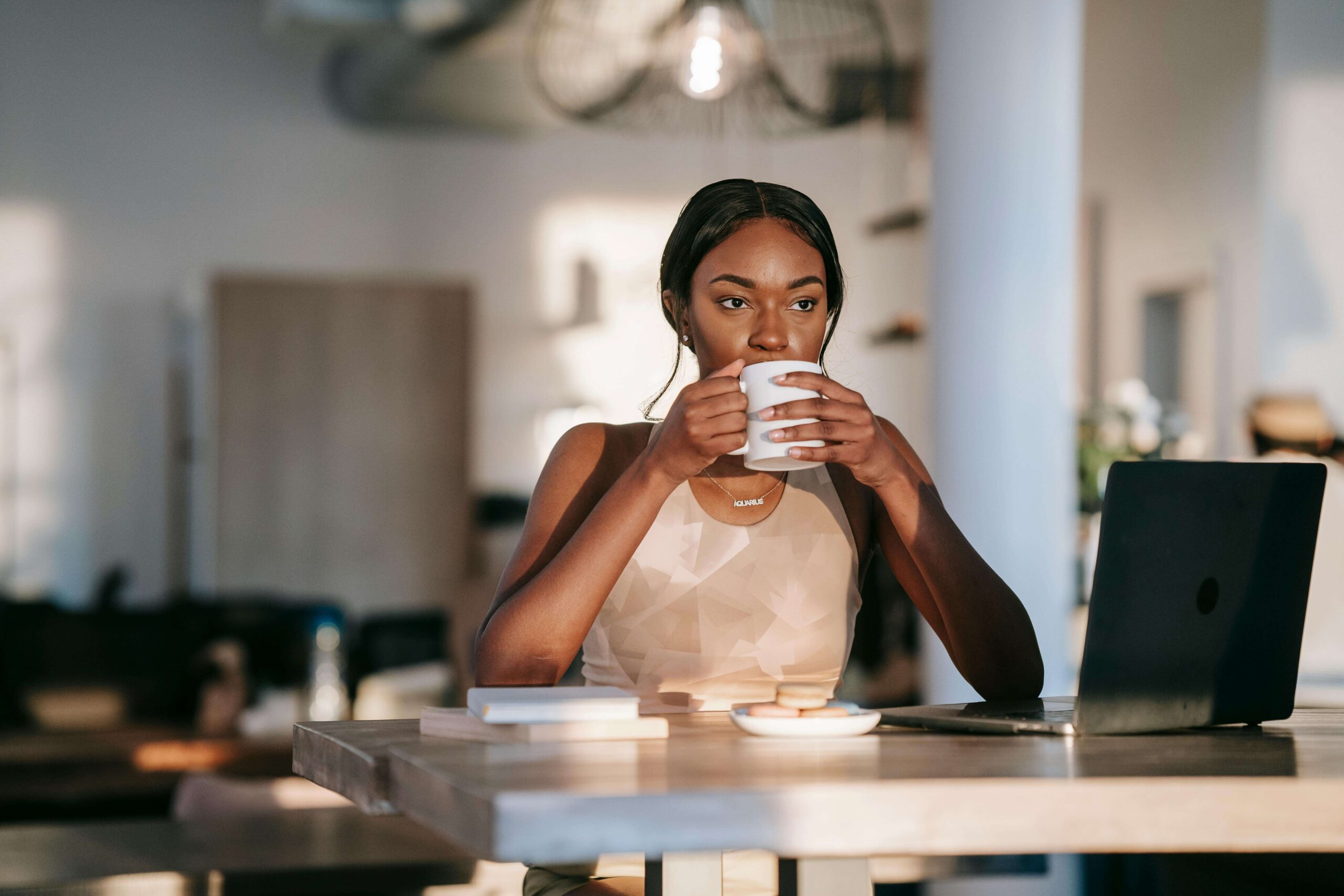 person drinking a coffee at a desk