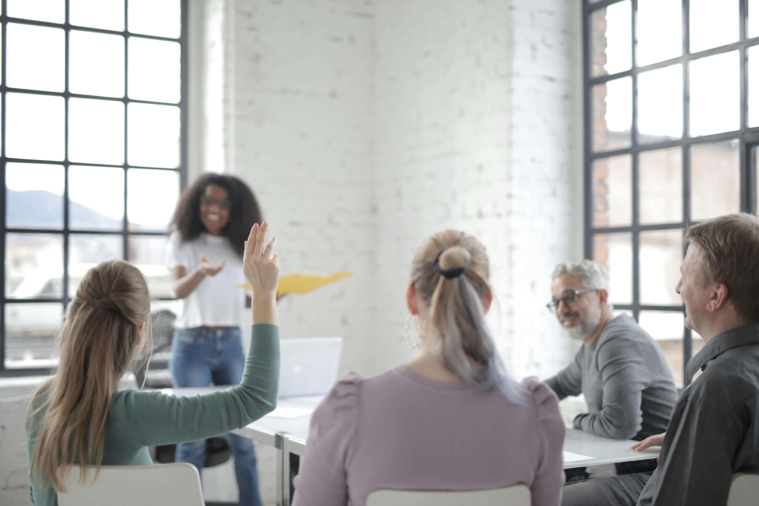 group of people and one person with hand up