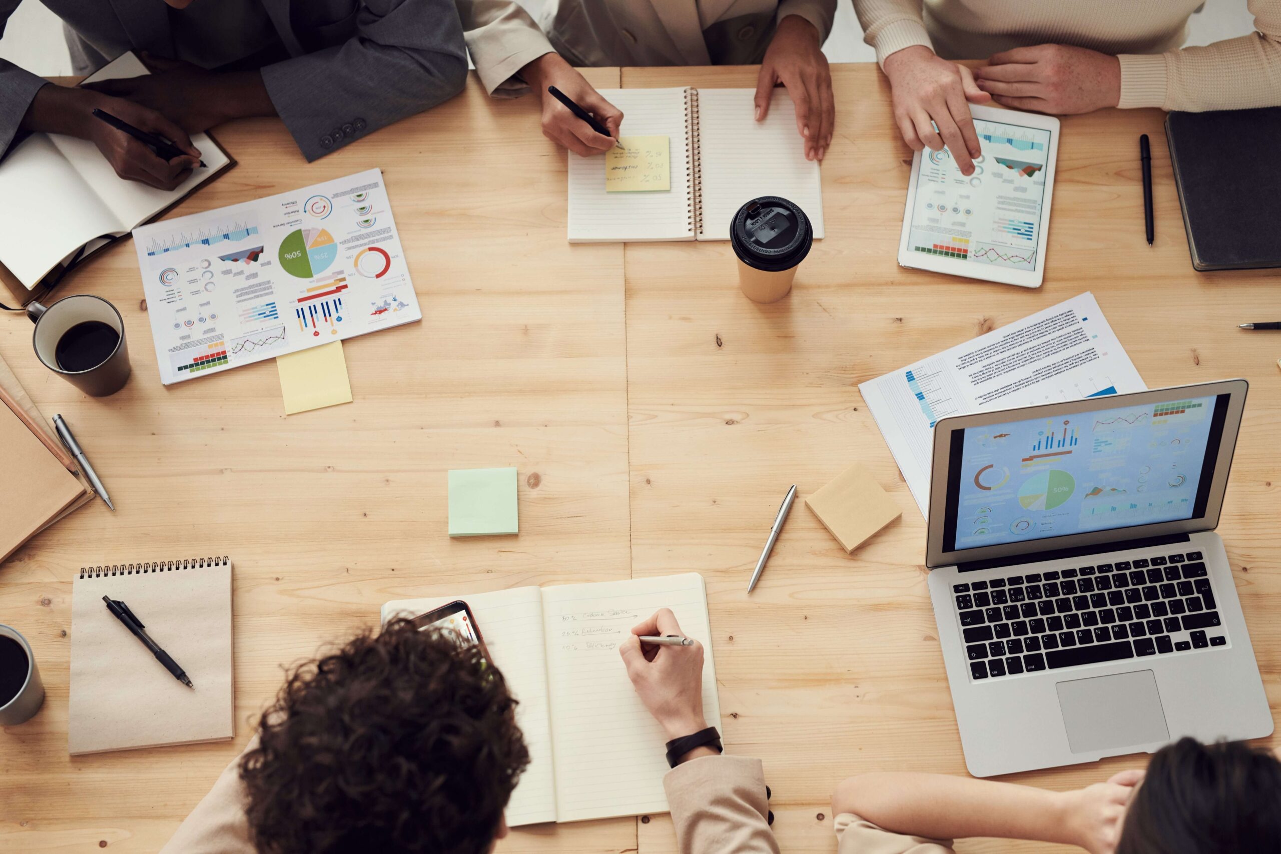people in a meeting around a wooden table